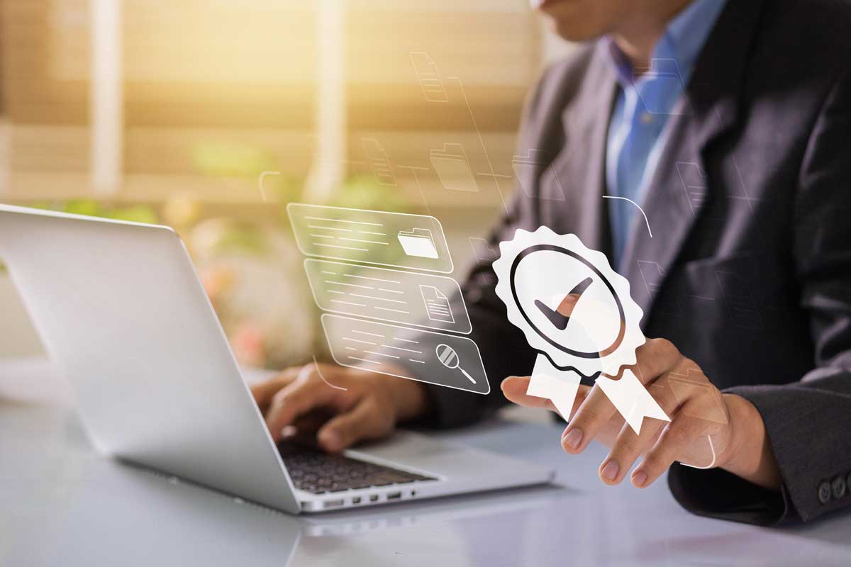 Uomo in giacca al computer con icona digitale di certificato e segno di spunta, simbolo di qualità e conformità.